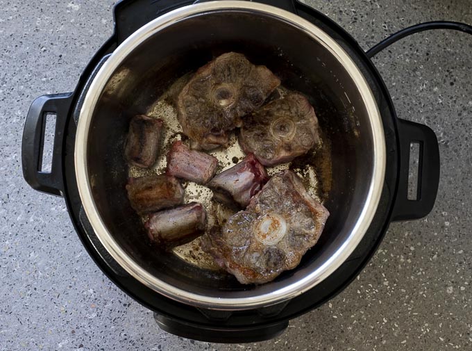 browned oxtails in a pot