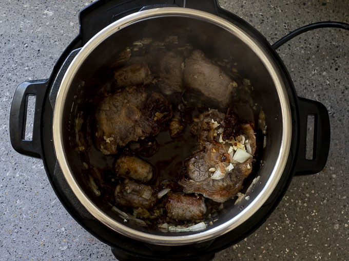 oxtails and liquid in a pot