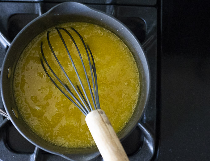 yellow mixture in a saucepan with a whisk