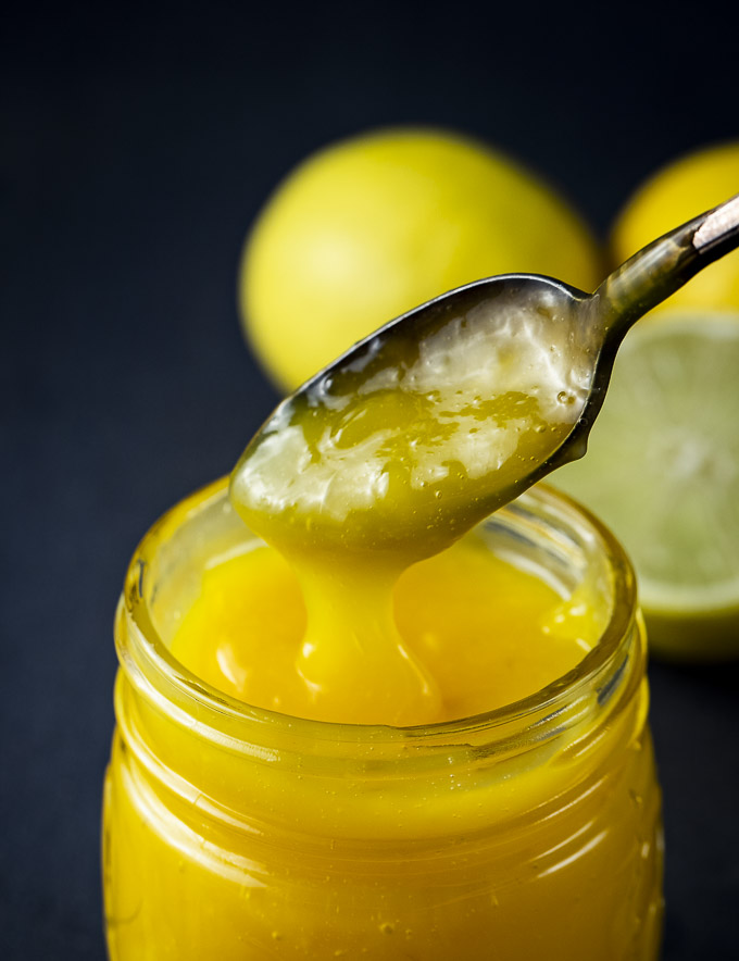 a spoon of lime curd in a jar