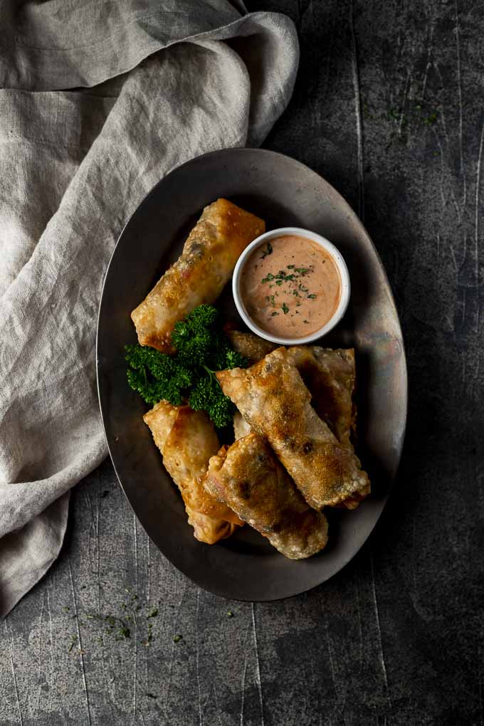 plate of fried egg rolls with dipping sauce