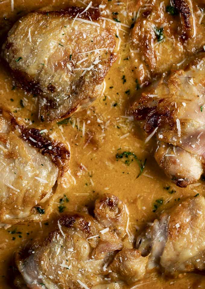 close up of chicken in creamy orange colored sauce