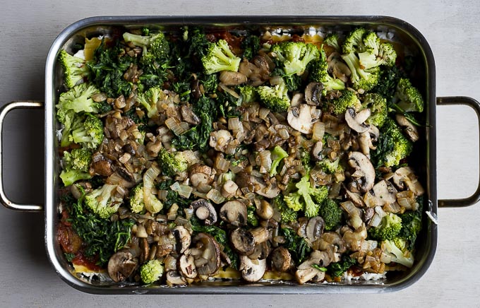 mushroom, spinach and broccoli in a lasagna pan