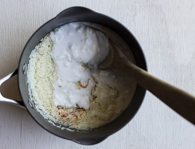 rice and coconut milk in a saucepan