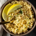 bowl of rice with limes and a spoon