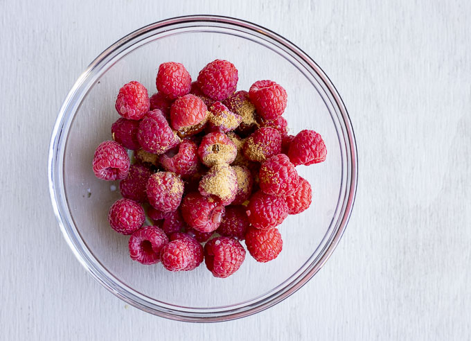 raspberries in a bowl with sugar