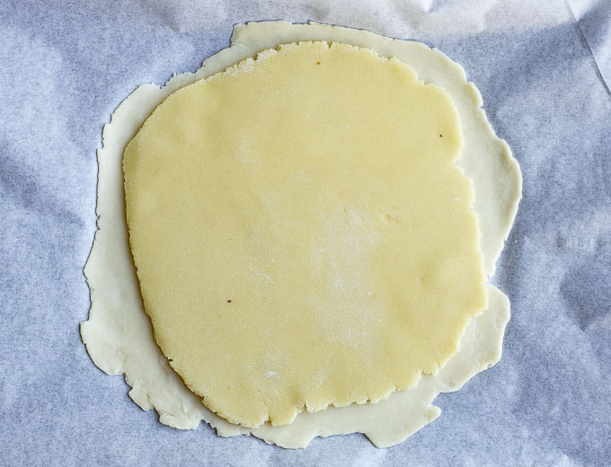 rolled out almond paste on top of an unbaked pie crust