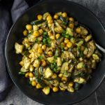 bowl of roasted zucchini and chickpeas garnished with green onions