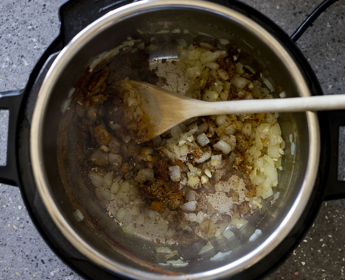 onions garlic and spices cooking in a pot