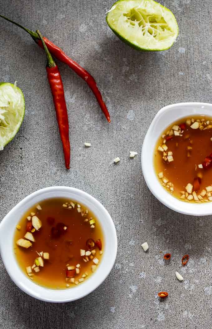 2 bowls of vietnamese dipping sauce with chilies and garlic