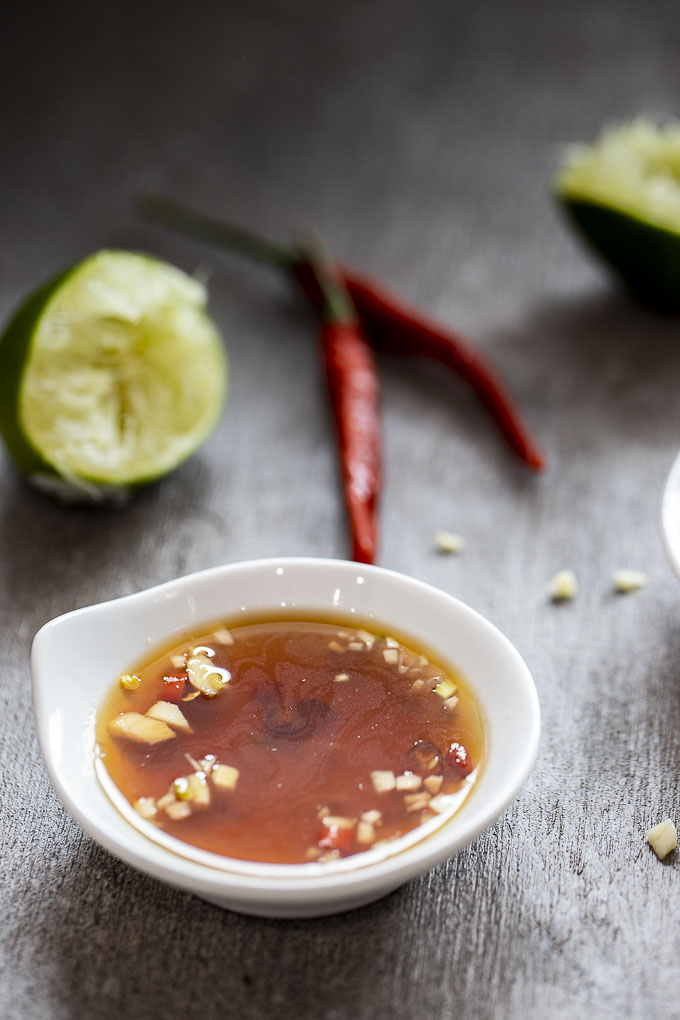 bowl of clear brown sauce with garlic and chilies
