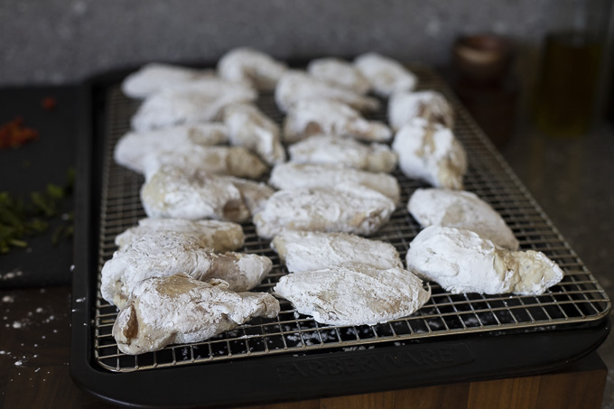 chicken wings coated with cornstarch on a wire rack