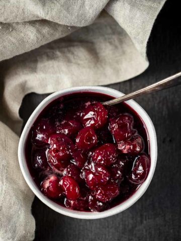 candied cherries in a bowl with a spoon