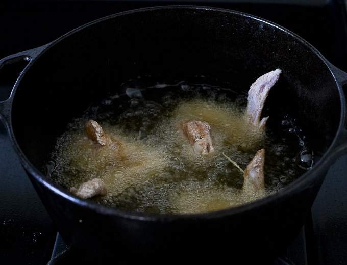 chicken wings frying in a pot