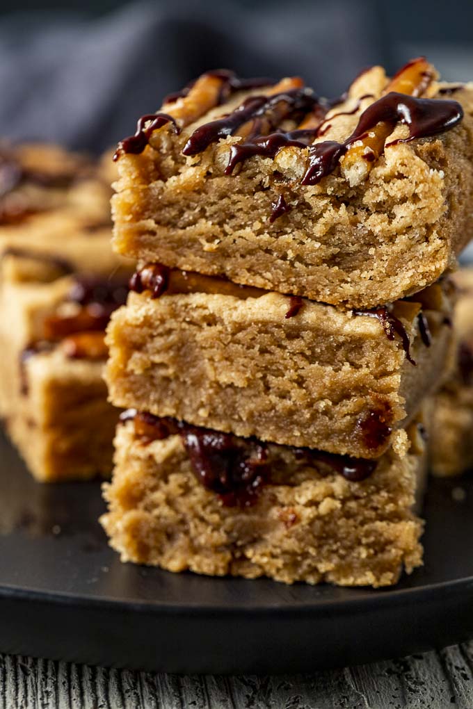 stack of peanut butter bars drizzled in chocolate