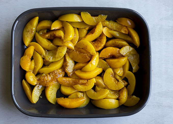 sliced peaches in a baking dish