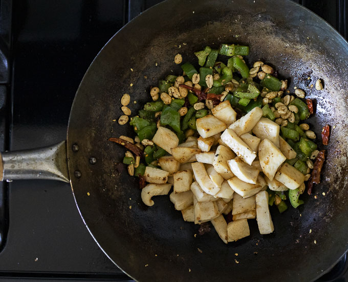peppers, chilies, peanuts and calamari in a wok