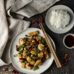 kung pao calamari on a plate with bowl of rice on the side