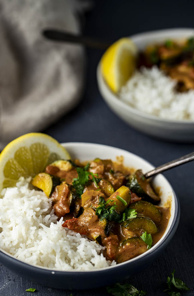 bowl of zucchini curry with lemon and rice