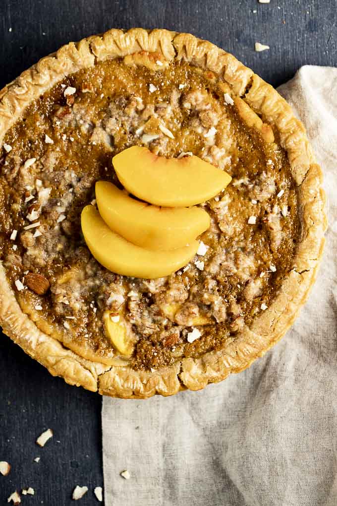 baked almond tart with sliced peaches on top