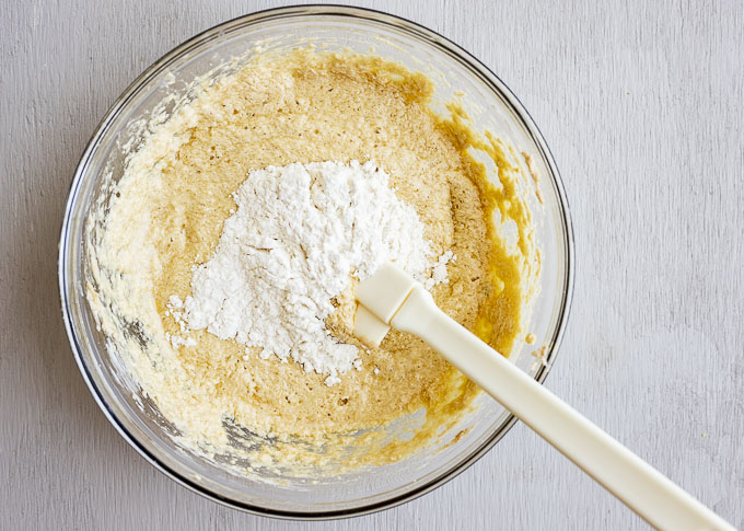 yellow batter in a bowl with flour