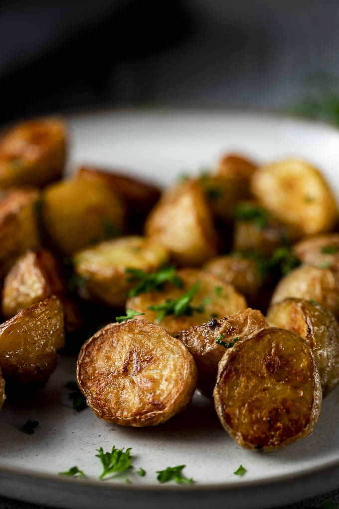 crispy potatoes on a plate with parsley