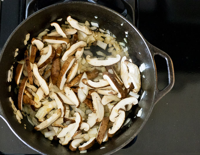 onions and sliced mushrooms cooking in a pot