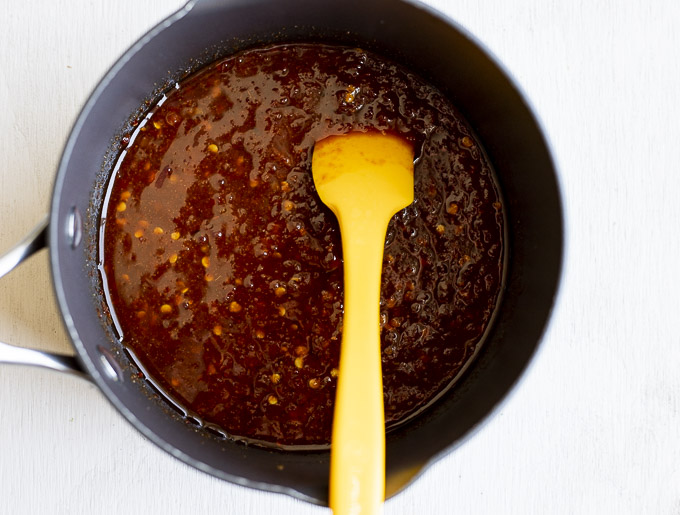 red chili sauce in a saucepan with a spoon