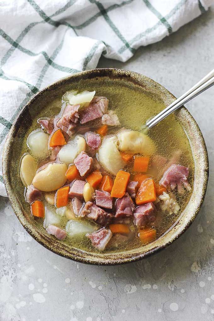 bowl of soup with ham and carrots