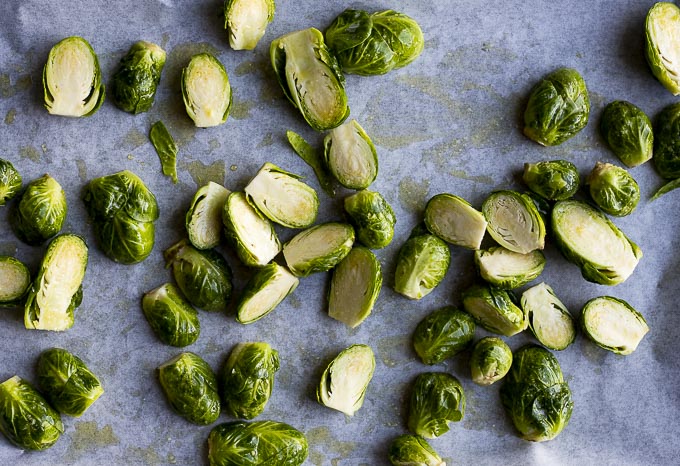 cut brussels sprouts on a baking sheet