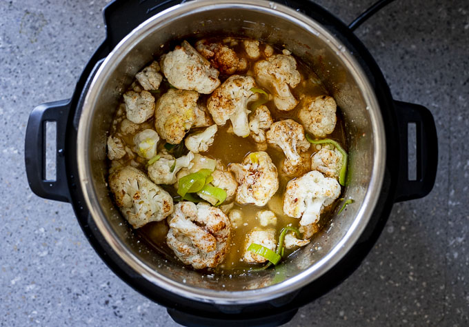 cauliflower with seasonings and liquid in a pot