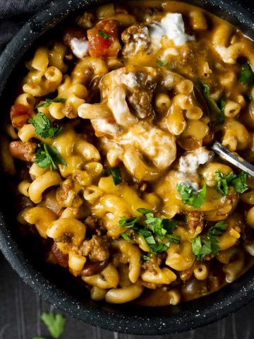 macaroni and meat sauce with cheese in a bowl with cilantro