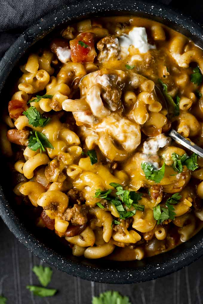 macaroni and meat sauce with cheese in a bowl with cilantro
