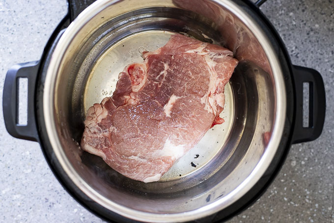 raw pork chop browning in instant pot