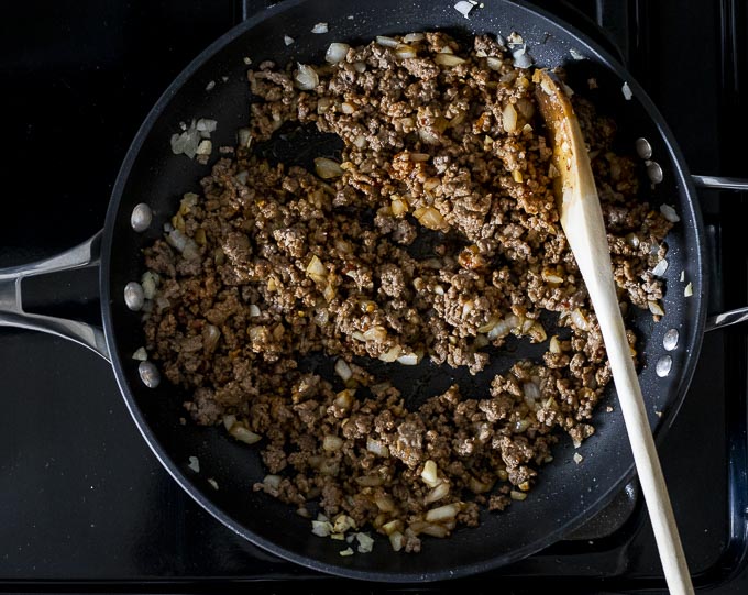ground beef with seasonings in a skillet