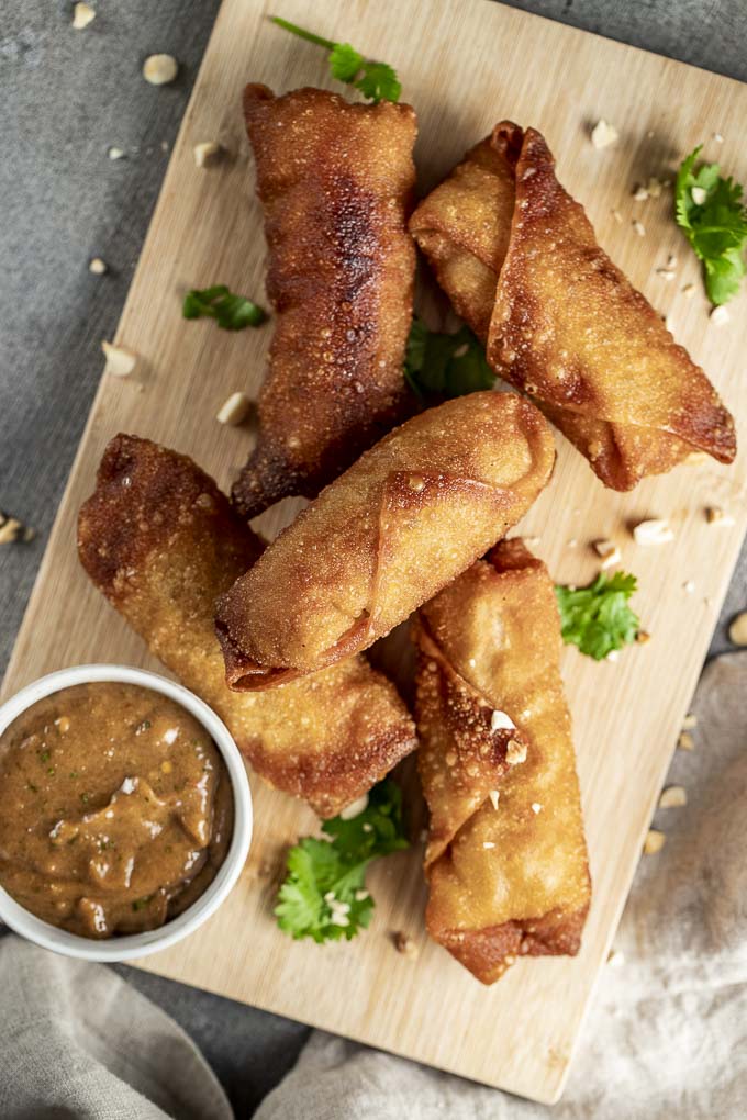 plate of egg rolls with peanut sauce