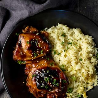 chicken thighs in a bowl with yellow rice