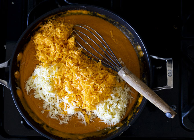 orange sauce with grated orange and white cheese in a skillet