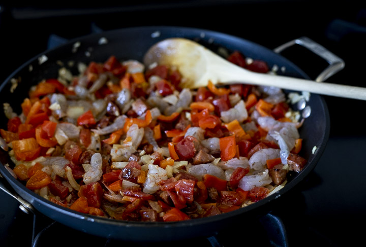 cut up vegetables sauteing in a skillet