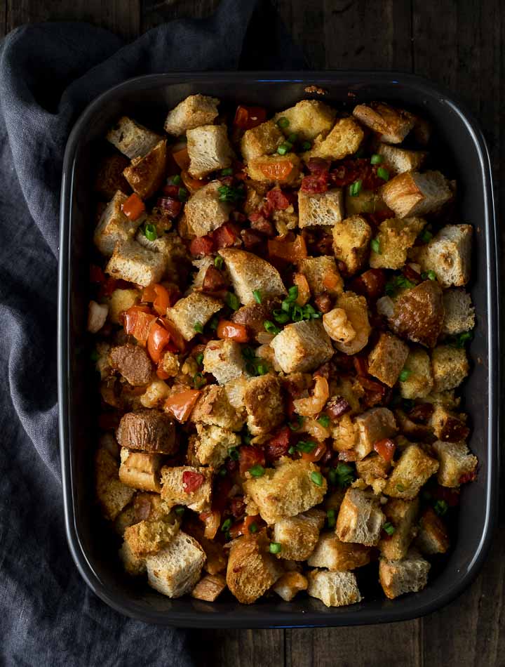 stuffing with red peppers and cilantro in a baking dish