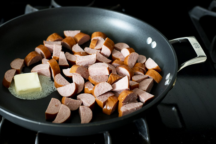sausage sauteing in a skillet