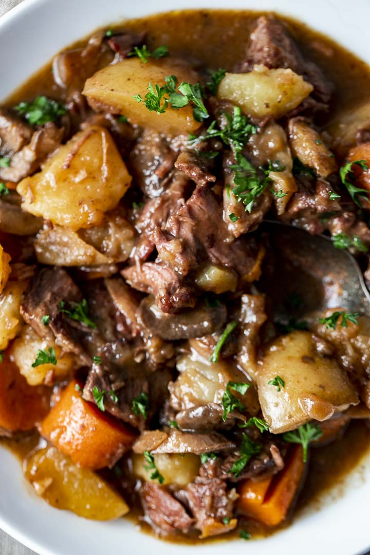 beef with potatoes and carrots garnished with parsley