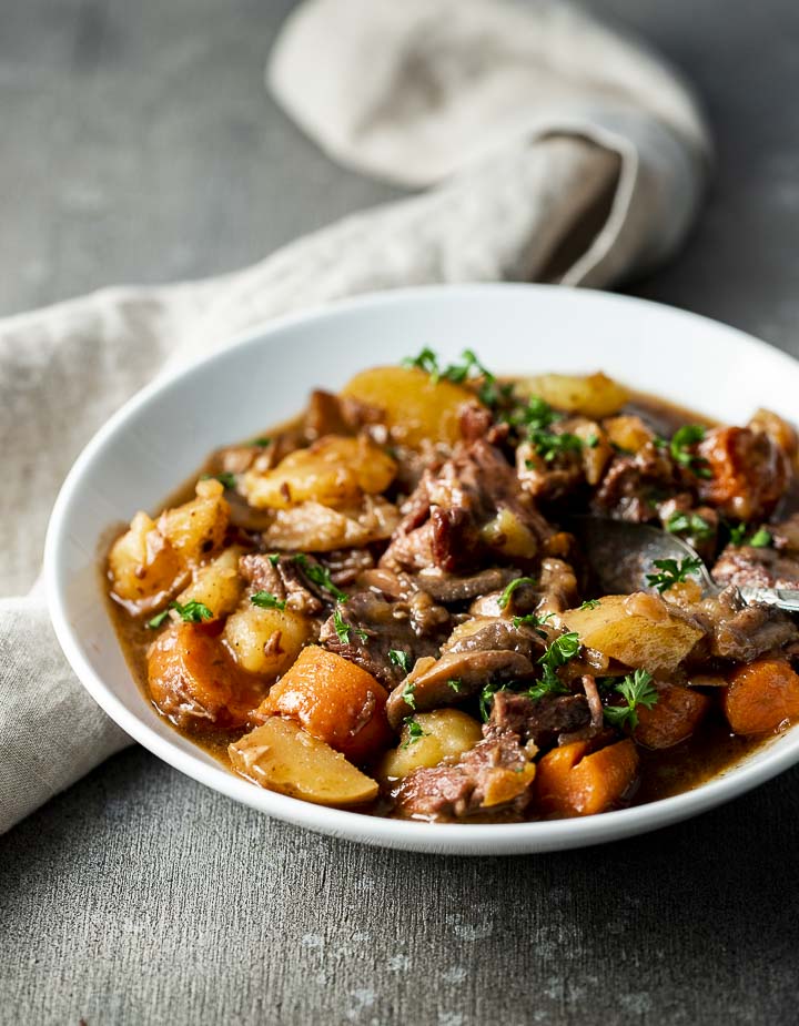 bowl of beef stewwith carrots and potatoes