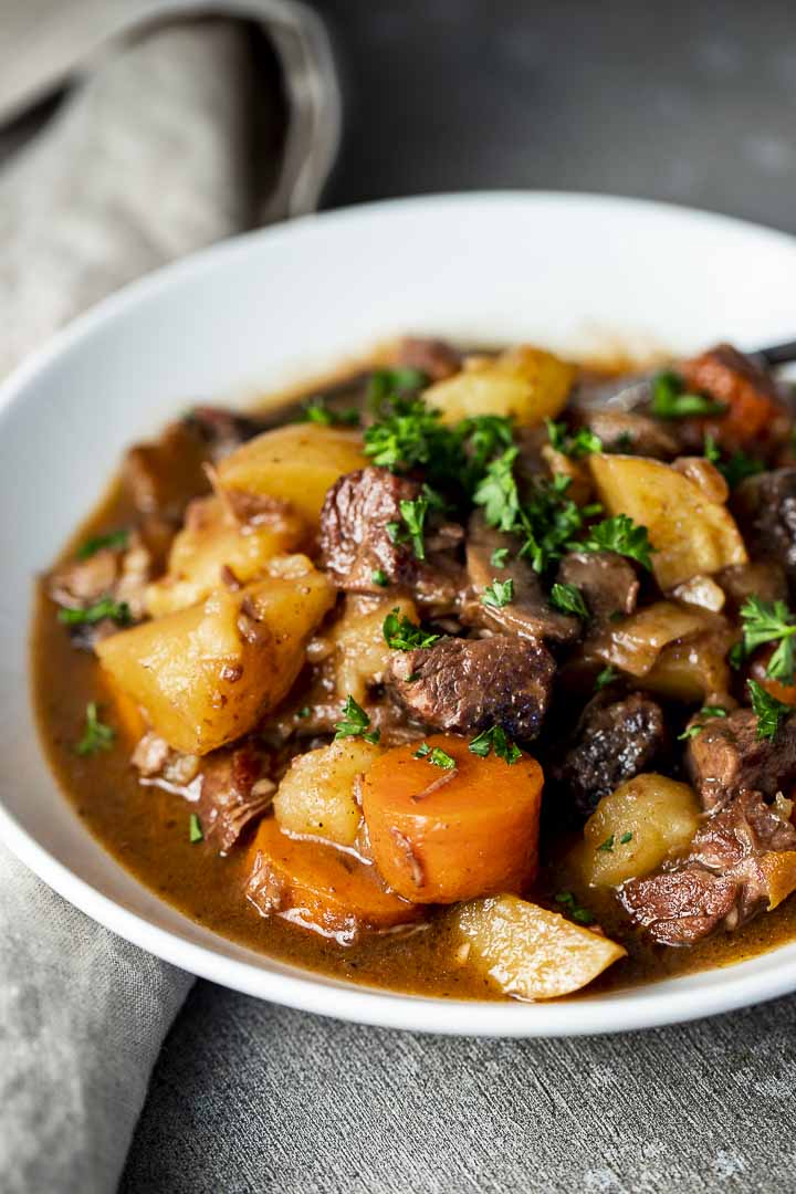 bowl of stew with beef, carrots and potatoes