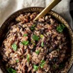 wild rice in a bowl with parsley and a spoon