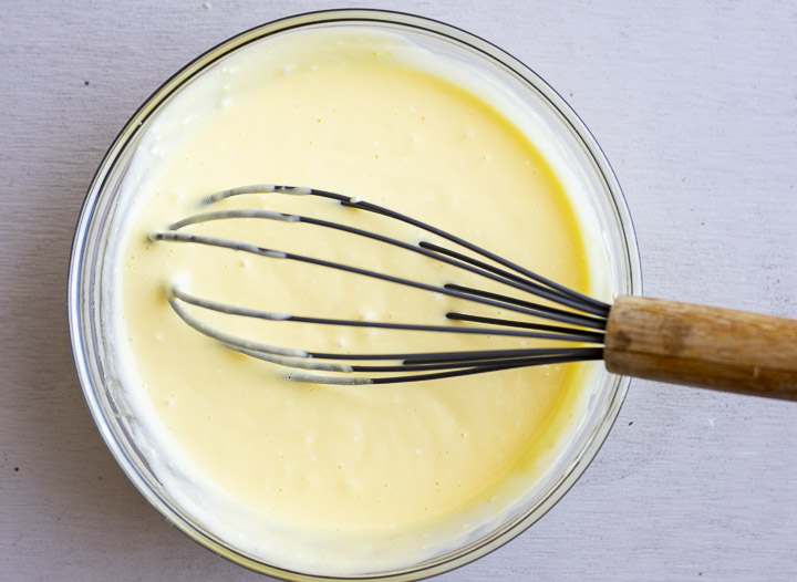yellow liquid in a bowl with a whisk