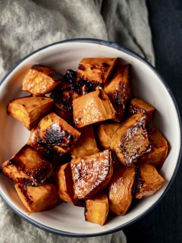 a bowl of caramelized sweet potatoes cut in cubes