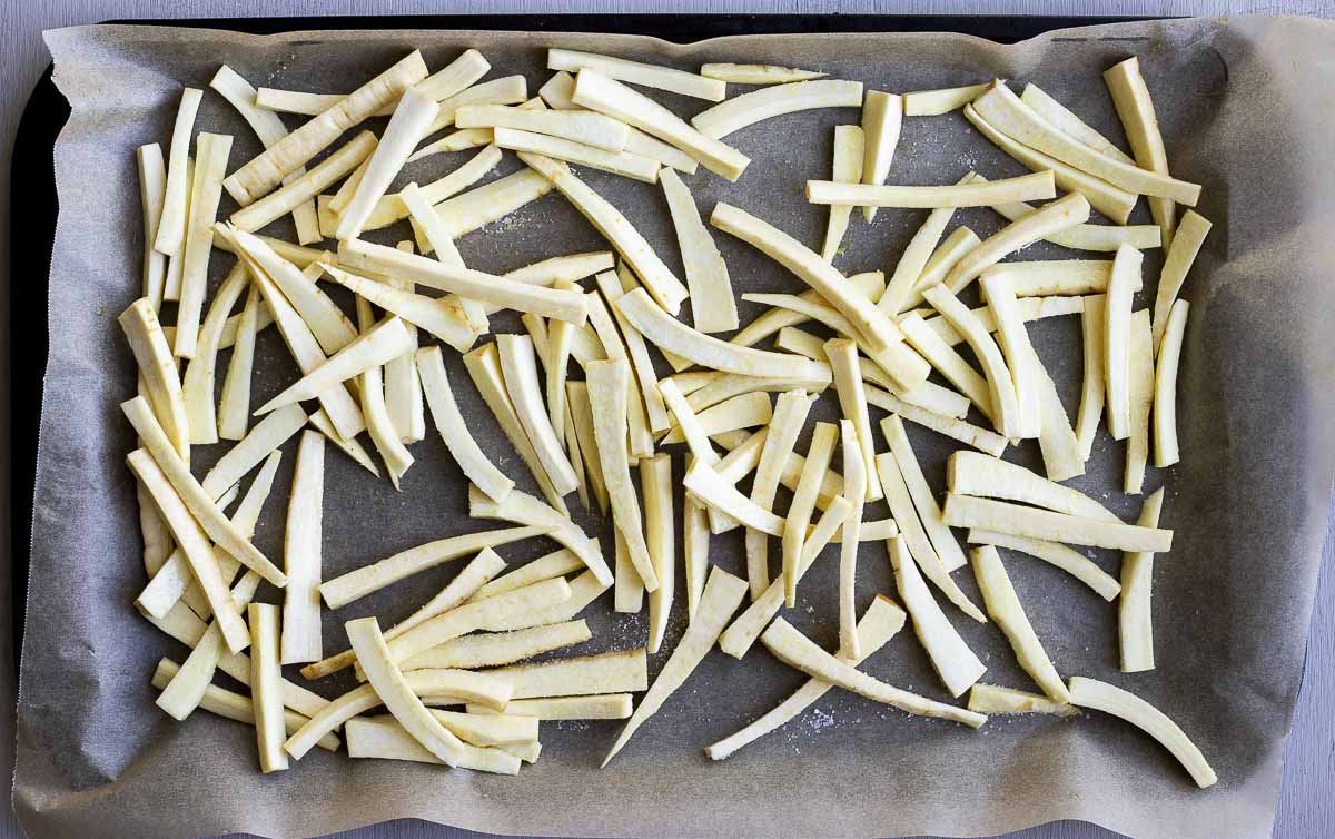 raw fries on a baking sheet