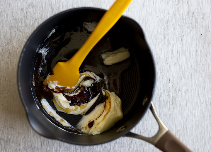 butter and dark sauce in a pot with a spatula