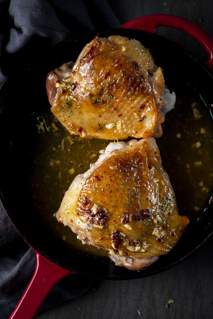 turkey thighs cooking in a skillet